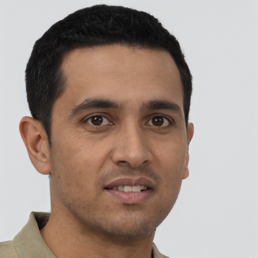 Joyful latino young-adult male with short  black hair and brown eyes