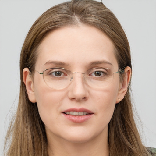 Joyful white young-adult female with long  brown hair and blue eyes