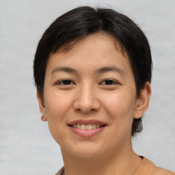 Joyful asian young-adult female with short  brown hair and brown eyes