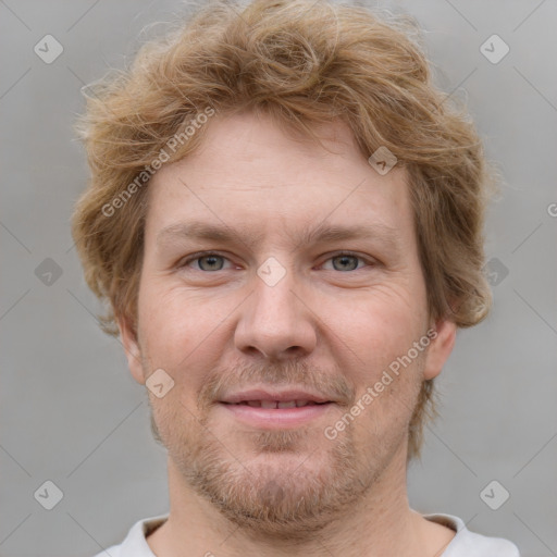 Joyful white adult male with short  brown hair and grey eyes