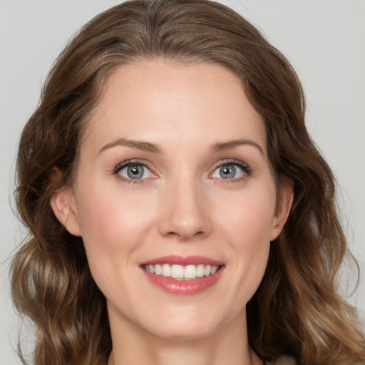 Joyful white young-adult female with medium  brown hair and green eyes