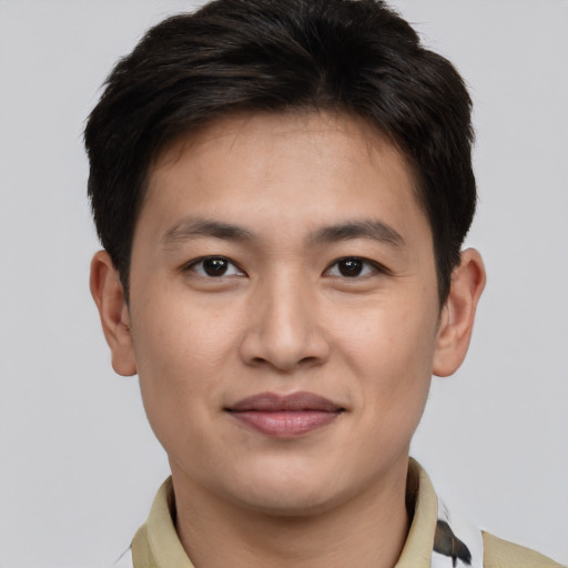 Joyful asian young-adult male with short  brown hair and brown eyes
