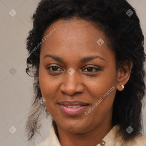 Joyful black adult female with medium  brown hair and brown eyes