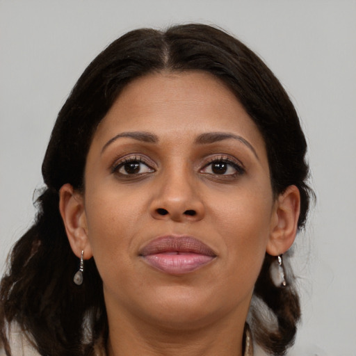 Joyful black young-adult female with medium  brown hair and brown eyes
