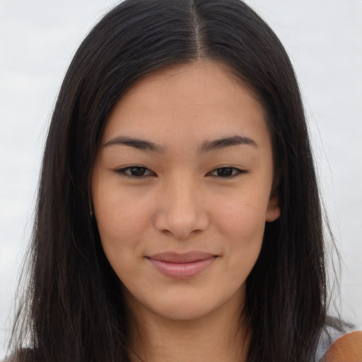 Joyful asian young-adult female with long  brown hair and brown eyes