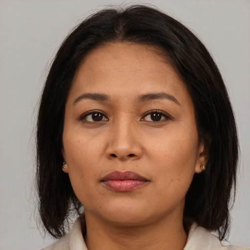 Joyful asian adult female with medium  brown hair and brown eyes