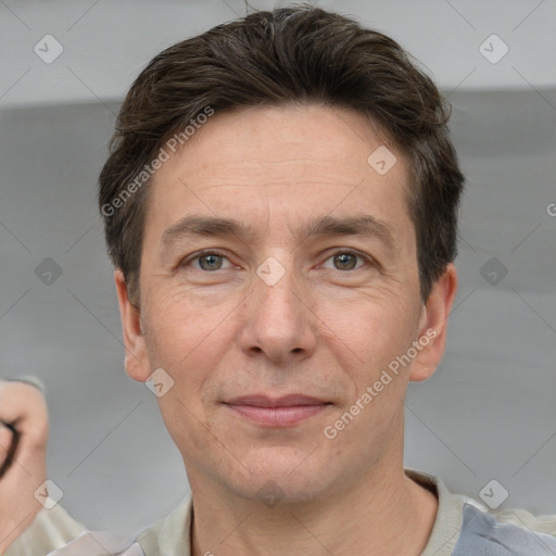 Joyful white adult male with short  brown hair and grey eyes