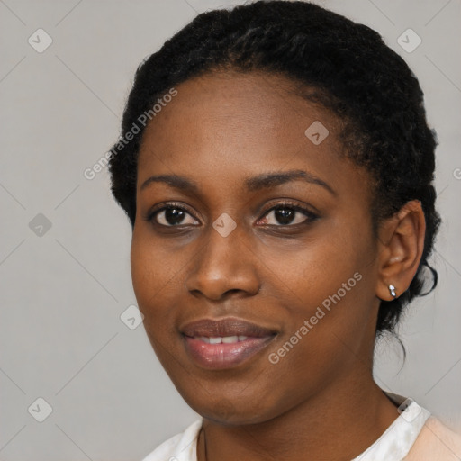 Joyful black young-adult female with short  black hair and brown eyes