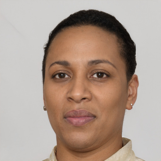 Joyful black adult female with short  brown hair and brown eyes