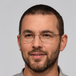 Joyful white adult male with short  brown hair and brown eyes