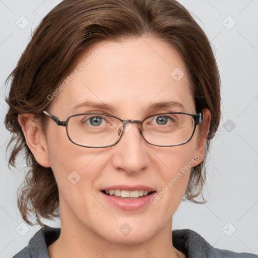 Joyful white adult female with medium  brown hair and blue eyes