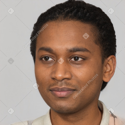 Joyful black young-adult male with short  black hair and brown eyes