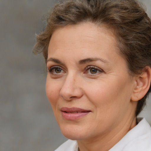 Joyful white adult female with short  brown hair and brown eyes