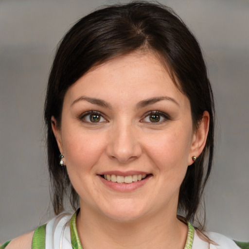 Joyful white young-adult female with medium  brown hair and brown eyes