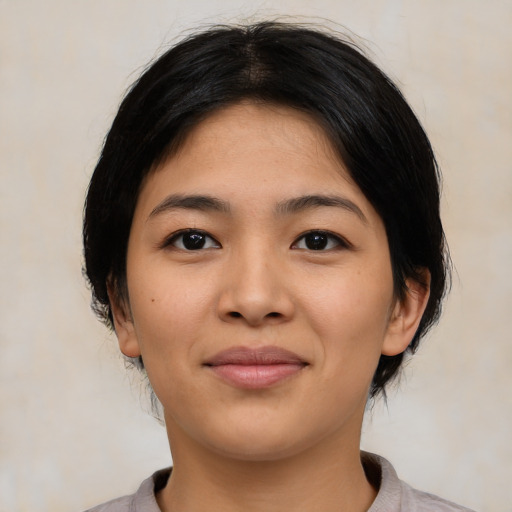 Joyful asian young-adult female with medium  black hair and brown eyes
