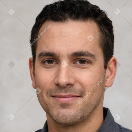 Joyful white adult male with short  brown hair and brown eyes