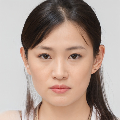 Joyful asian young-adult female with medium  brown hair and brown eyes