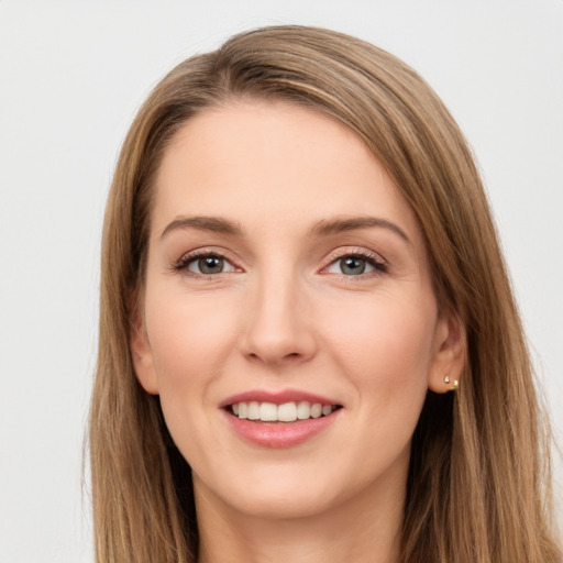 Joyful white young-adult female with long  brown hair and green eyes