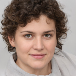 Joyful white young-adult female with medium  brown hair and green eyes