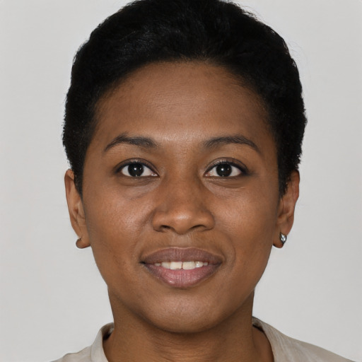 Joyful black young-adult female with short  black hair and brown eyes