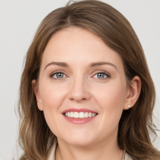 Joyful white young-adult female with medium  brown hair and grey eyes