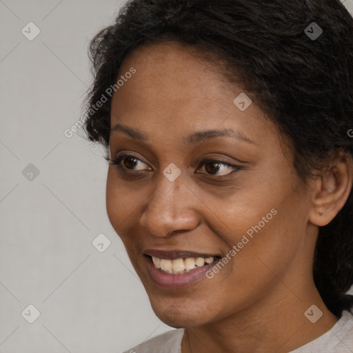 Joyful black young-adult female with short  brown hair and brown eyes