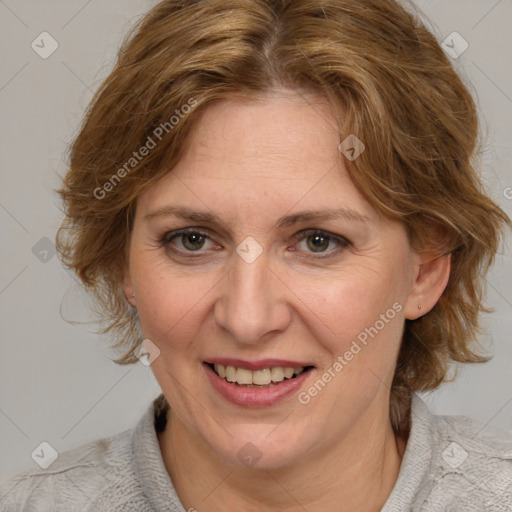 Joyful white adult female with medium  brown hair and blue eyes