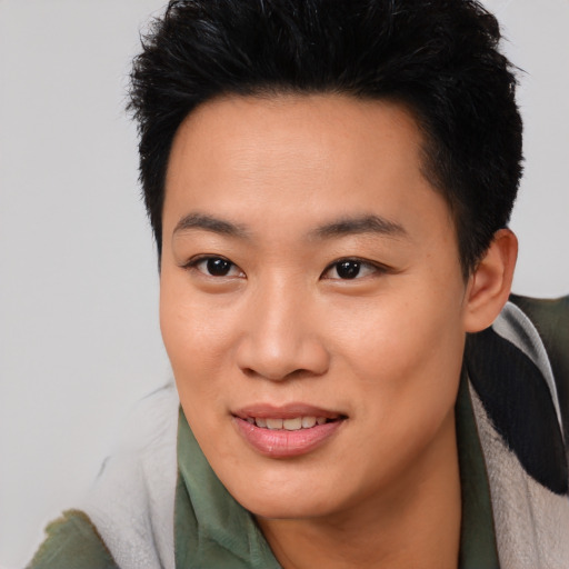 Joyful asian young-adult female with short  black hair and brown eyes