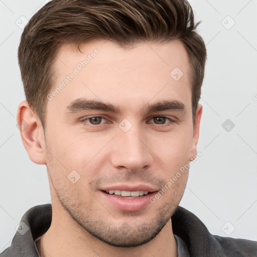 Joyful white young-adult male with short  brown hair and grey eyes