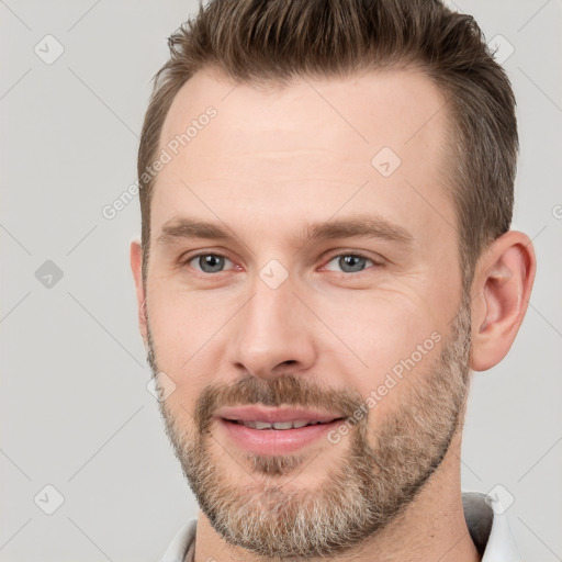 Joyful white adult male with short  brown hair and brown eyes