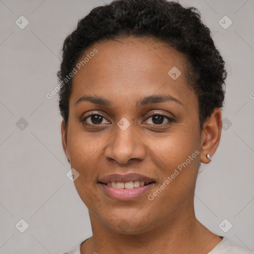 Joyful black young-adult female with short  brown hair and brown eyes