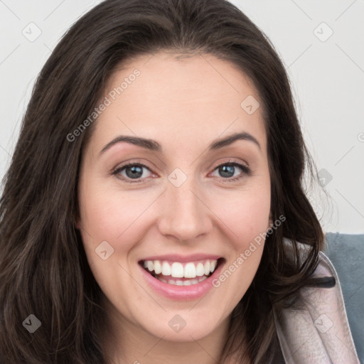 Joyful white young-adult female with long  brown hair and blue eyes