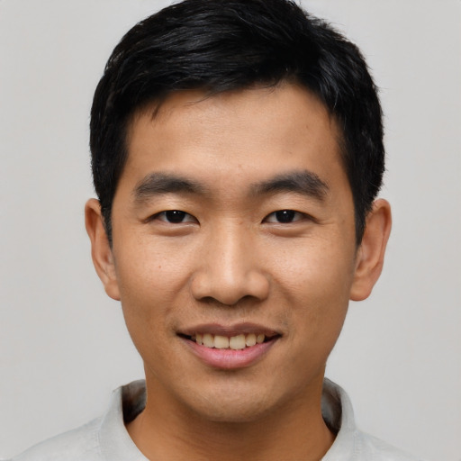 Joyful asian young-adult male with short  black hair and brown eyes