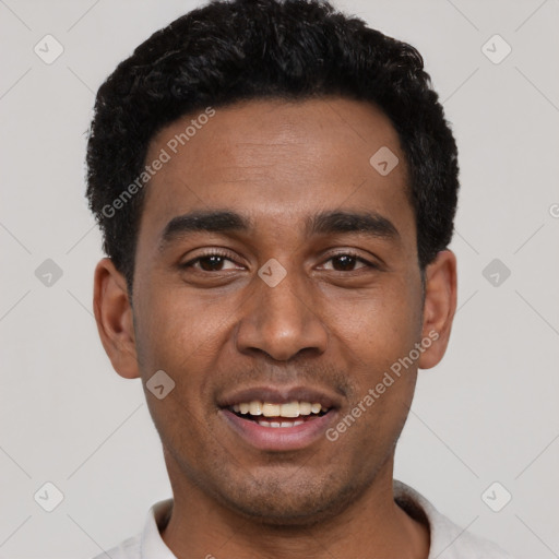 Joyful black young-adult male with short  black hair and brown eyes