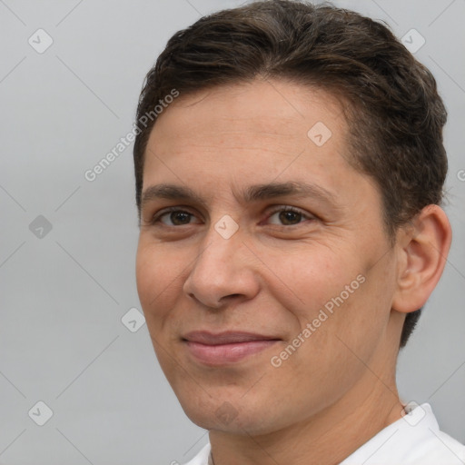 Joyful white adult male with short  brown hair and brown eyes