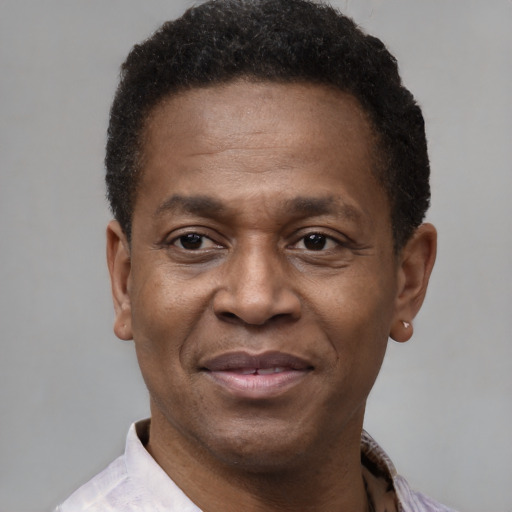 Joyful black adult male with short  brown hair and brown eyes