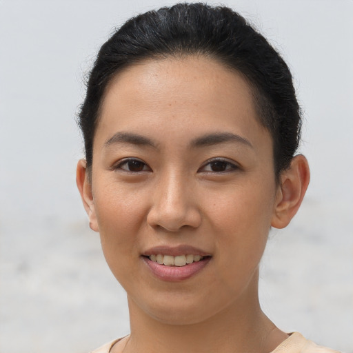 Joyful asian young-adult female with short  brown hair and brown eyes