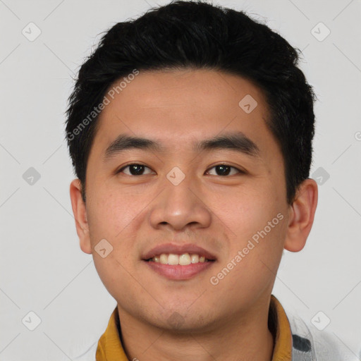 Joyful asian young-adult male with short  black hair and brown eyes