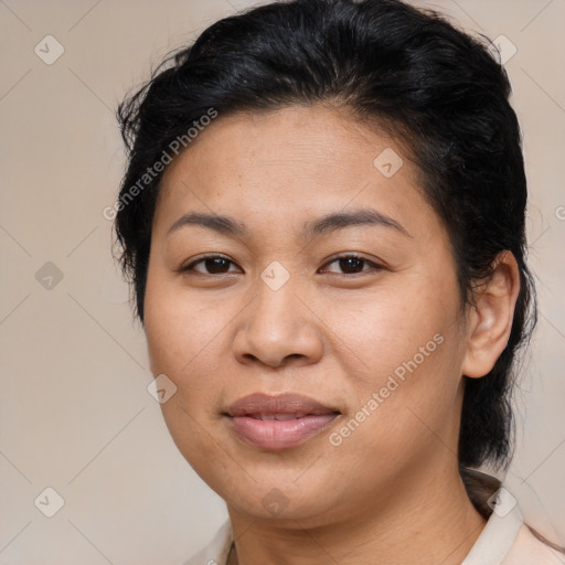 Joyful latino adult female with medium  brown hair and brown eyes