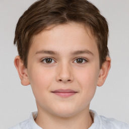 Joyful white child male with short  brown hair and brown eyes