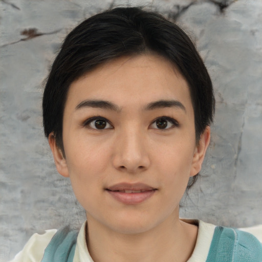 Joyful asian young-adult female with short  brown hair and brown eyes