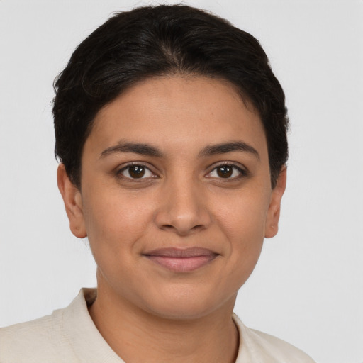 Joyful latino young-adult female with short  brown hair and brown eyes