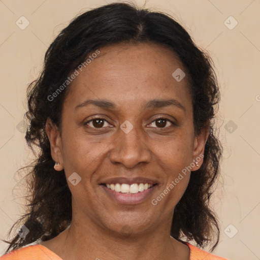 Joyful latino adult female with medium  brown hair and brown eyes