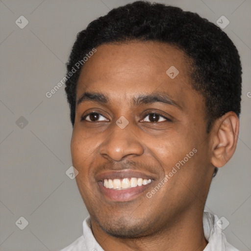 Joyful black young-adult male with short  black hair and brown eyes