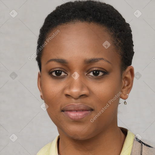 Joyful black young-adult female with short  black hair and brown eyes