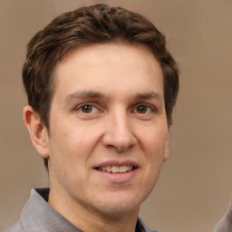 Joyful white adult male with short  brown hair and grey eyes