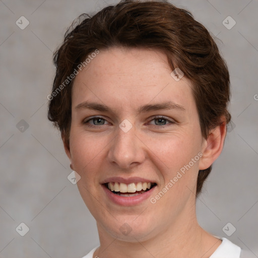 Joyful white young-adult female with short  brown hair and grey eyes