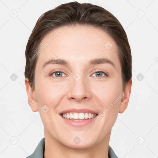 Joyful white young-adult female with short  brown hair and grey eyes