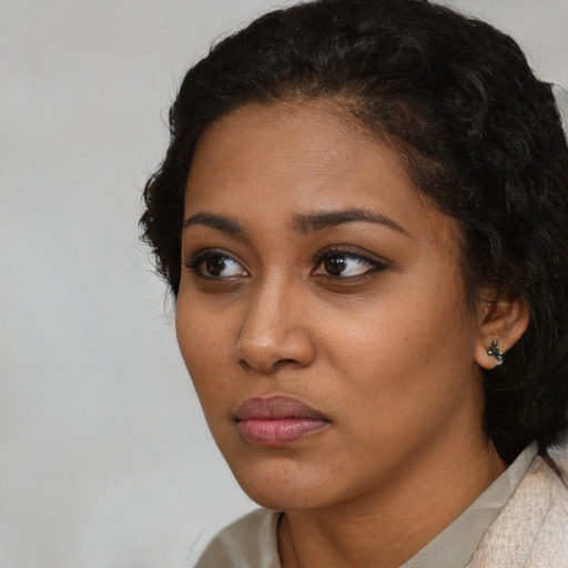 Neutral black young-adult female with medium  brown hair and brown eyes