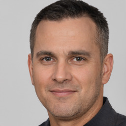 Joyful white adult male with short  brown hair and brown eyes